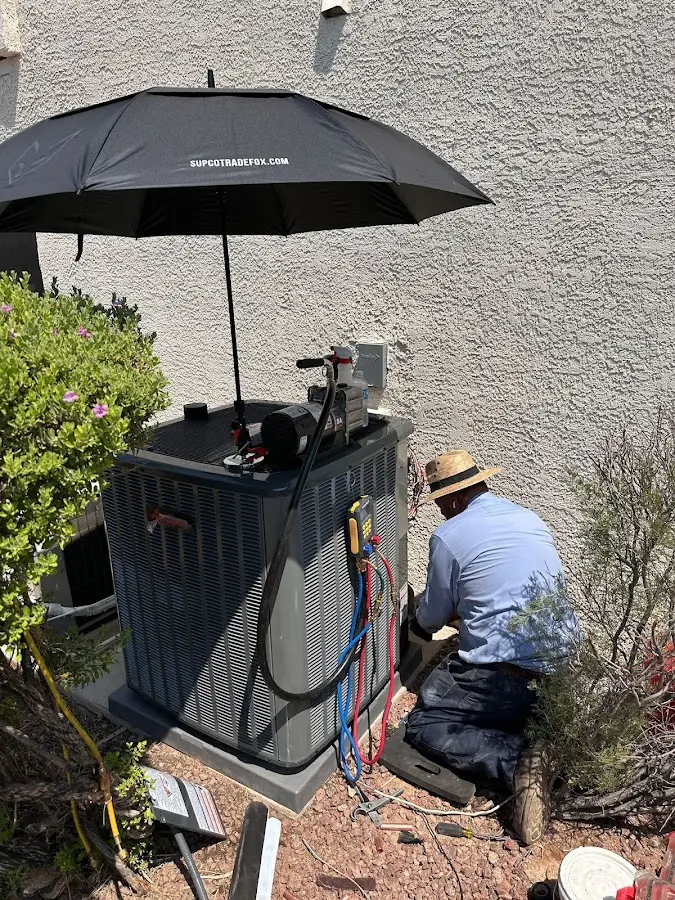 HVAC technician performing outdoor AC maintenance in Plano